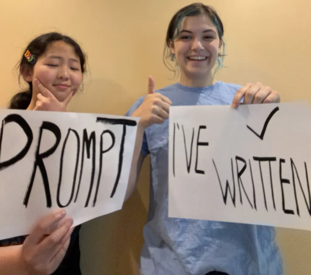 Club members holding signs reading Prompt I've Written